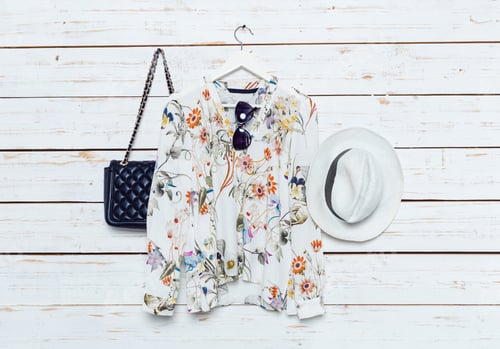 Preview: Female shirt hang on wooden background with accessories