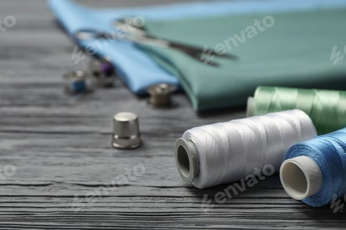 Preview: Sewing threads and accessories on wooden background
