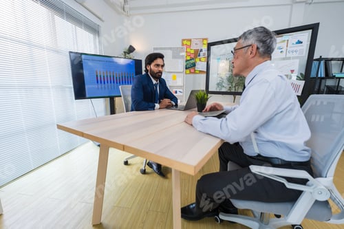 Preview: Business Professionals Discussing Project in Modern Office