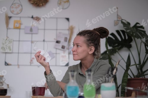 Preview: woman looks through a glass blank for a panel