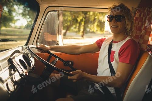 Preview: Smiling man driving camper va