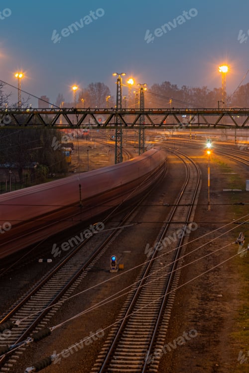 Preview: Vertical long exposure shot of a train in Hungary, Bekescsaba, at night