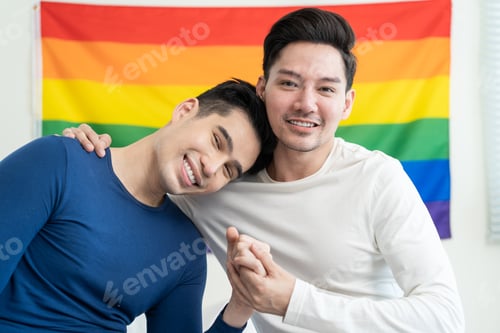 Preview: Portrait of Asian handsome man gay family holding LGBT flag and smile.