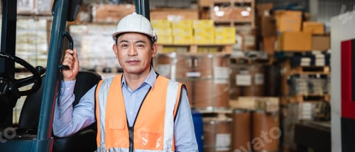 Preview: Portrait of a woman working with a forklift in a warehouse with her looking at the camera.