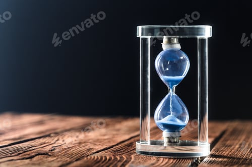 Preview: Modern hourglass on wooden background