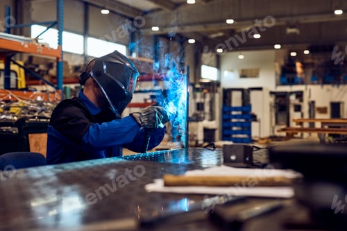 Preview: Welder Working in a Workshop with Sparks and Safety Equipment