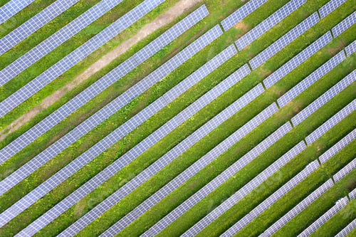 Preview: Aerial view of solar power plant on green field.