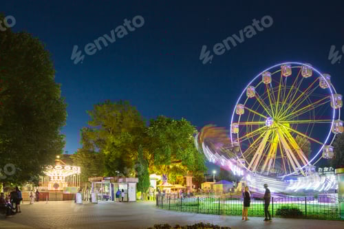 Preview: Attraction Ferris Wheel In Motion And Brightly Carousel Merry-Go
