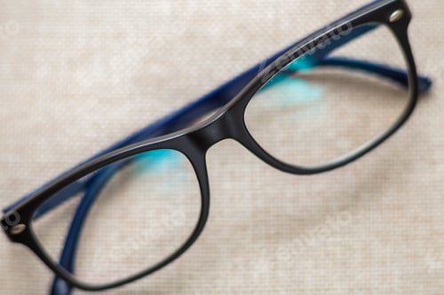 Preview: Stylish Black and Blue Glasses on Beige Fabric
