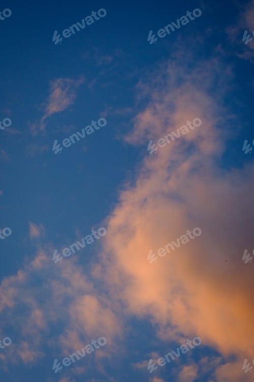 Preview: Vertical shot of the blue sky with pink clouds at sunset