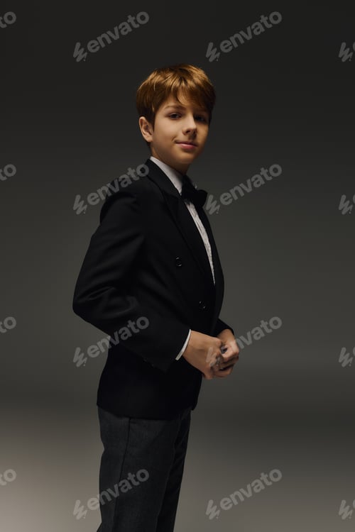 Preview: Elegant preteen boy showcases stylish fashion in a studio environment