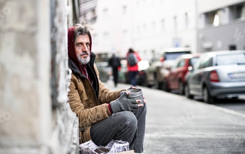 Preview: Homeless beggar man sitting outdoors in city asking for money donation.