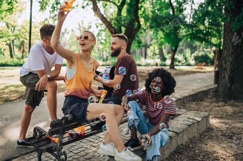 Preview: An interracial group of friends having fun in a city park.