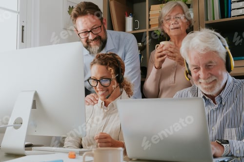 Group of old and middle age business people working and using computer and laptop discuss projects