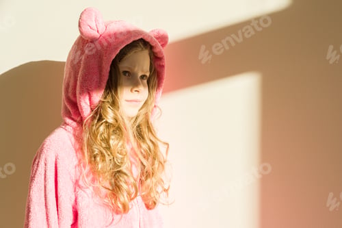 Preview: Portrait of a girl in soft warm pink pajamas.