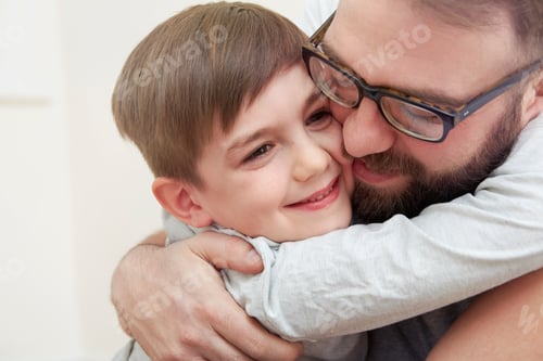 Preview: Mid adult man and son hugging each other
