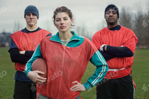 Preview: Two men and a woman, members of a team of American flag football players.