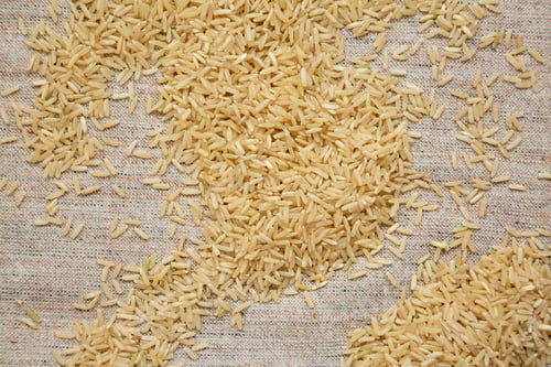 Preview: Dry Brown Rice on cloth, top view. Overhead, from above, flat lay.