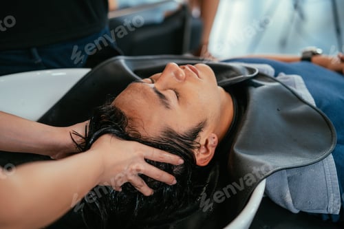 Preview: Barber washing head client in barbershop