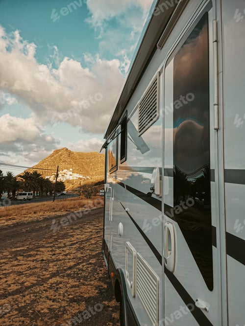 Preview: Close up of Travel vehicle concept with modern camper van motor home parked free in the nature