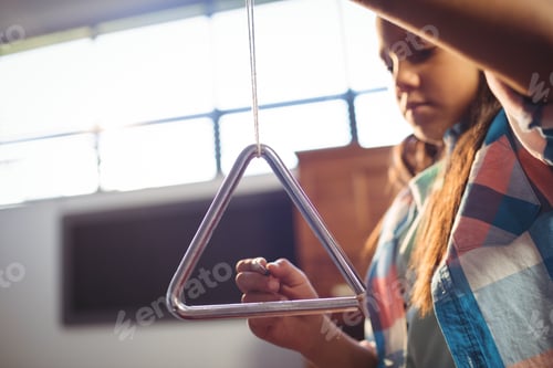 Preview: Low angle view of girl playing triangle
