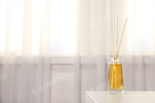 Preview: Reed air freshener on table indoors, space for text