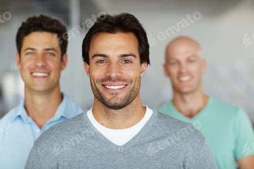 Preview: Shot of a young man standing in an office with male colleagues in the background
