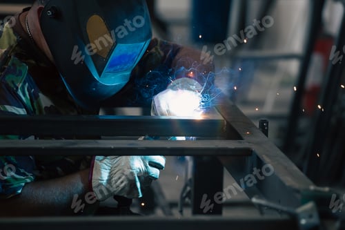 Preview: Industry worker welding iron pieces at work