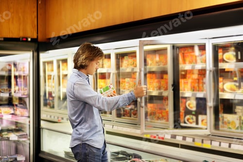 Preview: Man Choosing Frozen Food From A Supermarket Freezer