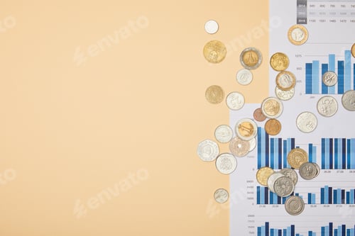 Preview: top view of papers with graphs and coins on table