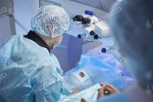 Preview: Male Surgeon Performing Eye Surgery on Senior Patient in Operating Room