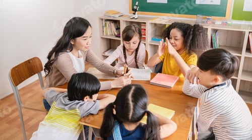 Preview: Pupils group study with teacher in classroom at elementary school