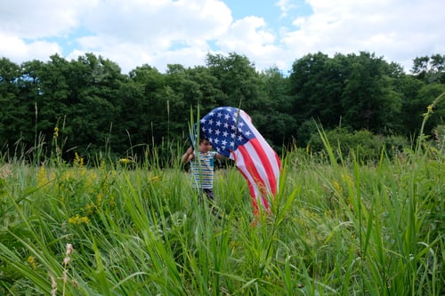 Preview: Patriotic holiday.Young boy with American flag.USA celebrate 4th of July.