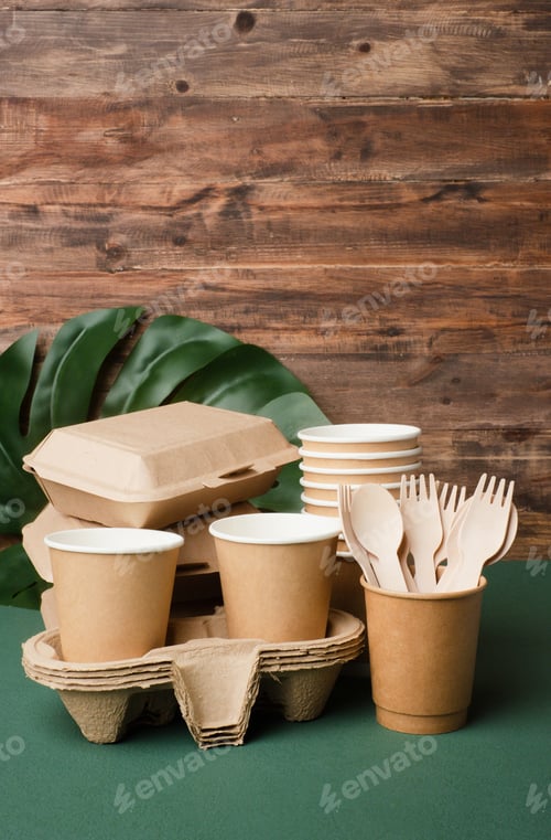 Preview: Eco friendly food ware,disposable cup ,food container, bamboo spoon fork on green table.sustainable