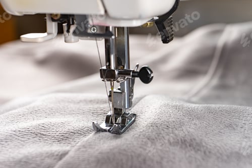 Preview: Modern sewing machine and gray fabric. Sewing process, handmade, hobby, DIY, business, repair