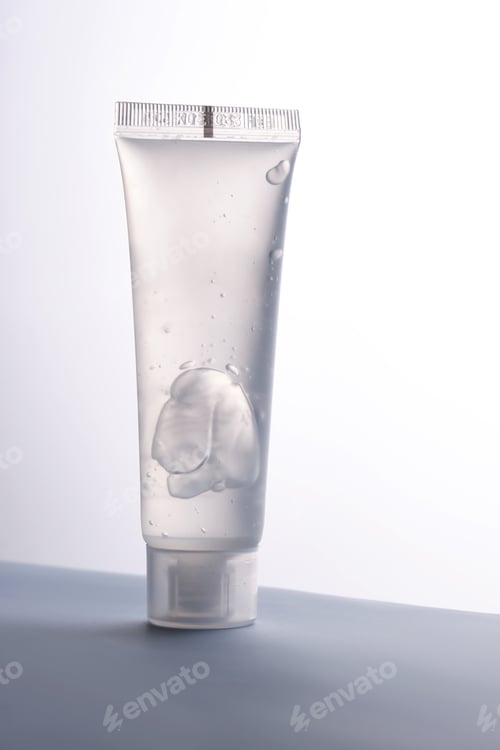 Preview: Transparent bottle of cosmetic gel on a white background.