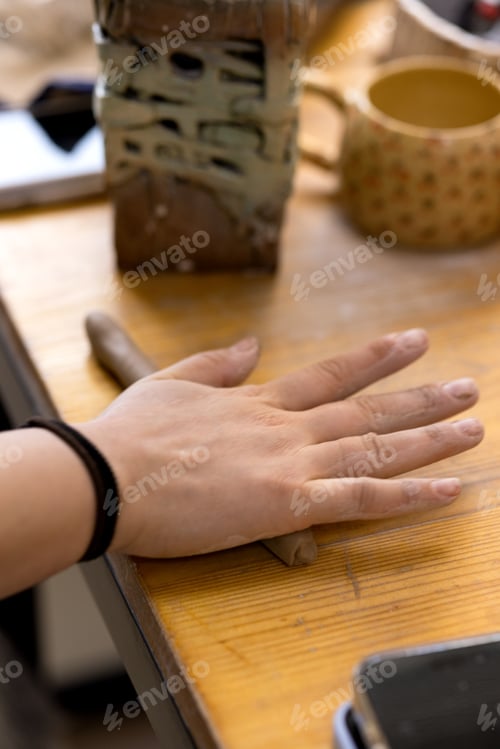 Preview: A woman's hand rolls clay on the table, starting the lesson. Master class