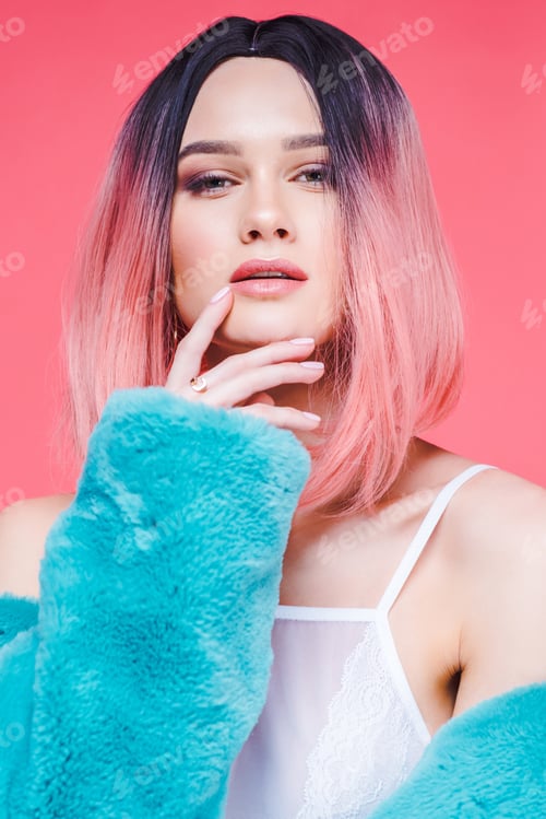 Preview: fashionable sensual girl with pink hair posing in blue fur coat, isolated on pink