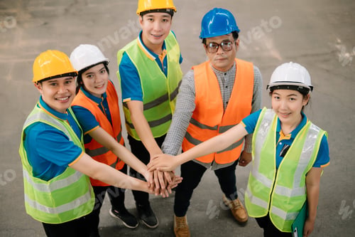 Preview: Happiness engineer and worker team group joining hands at cargo containers.