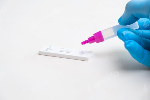 Preview: Drop reagent into COVID-19 Antigen test by laboratory worker in rubber gloves