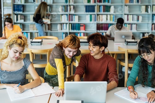 Preview: Young university students using laptop and studying with books in library - School education concept