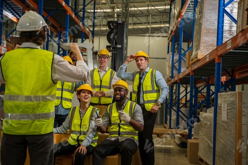 Preview: Cheerful logistics workers in a large distribution warehouse.