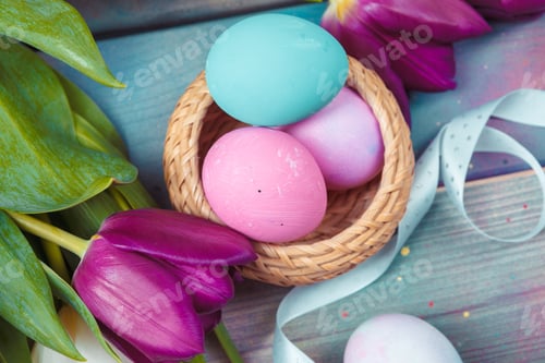 Preview: Easter eggs with tulips on blue wooden background