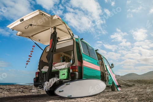 Preview: Caravan with surfboard and wet suit in sunlight