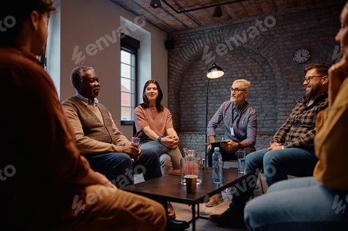 Preview: Multiracial group of people during mental health counseling at community center.