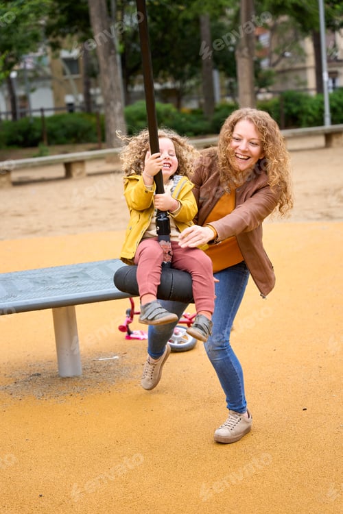 Preview: Mother playing with daughter at the park