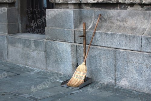 Preview: Street Cleaners Broom And Shovel Next To Wall