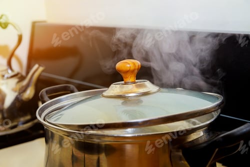 Preview: Chicken is cooked on a gas stove in a preparing chicken soup with herbs vegetables