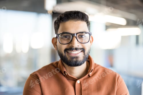 Preview: Smiling young indian man wearing glasses portrait