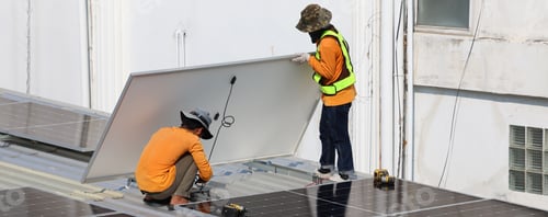 Preview: Technicians Install photovoltaic solar modules on roof of house.